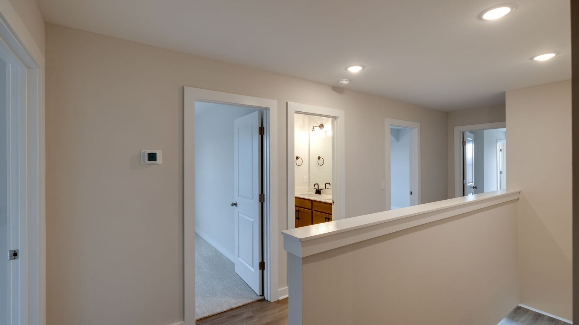 View from top of staircase with nearby bedrooms