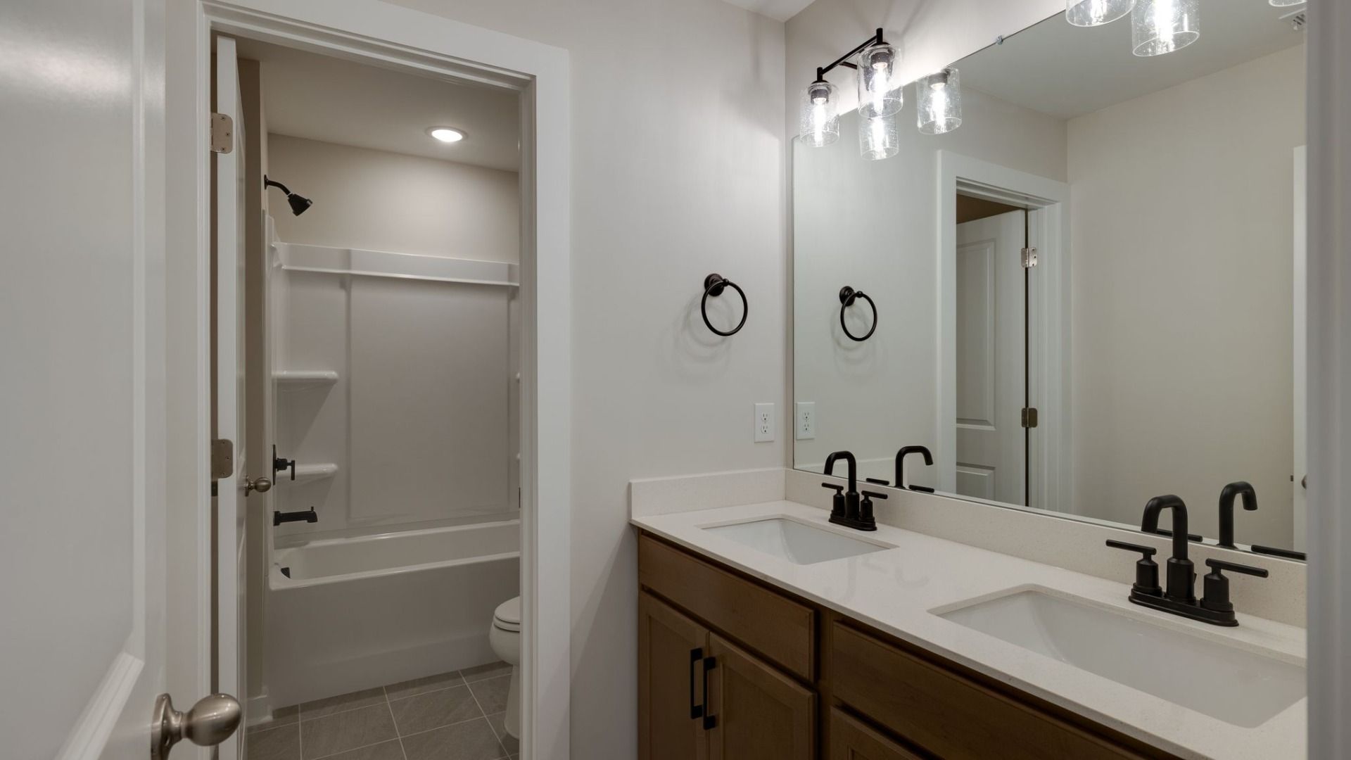 Bathroom with dual-vanity and separate water closet with shower