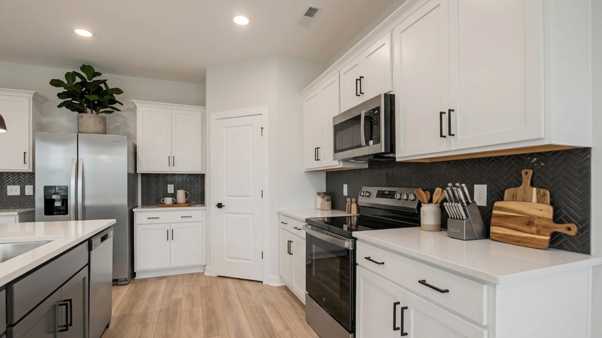 Kitchen with white cabinets and accent tile backsplash and corner pantry