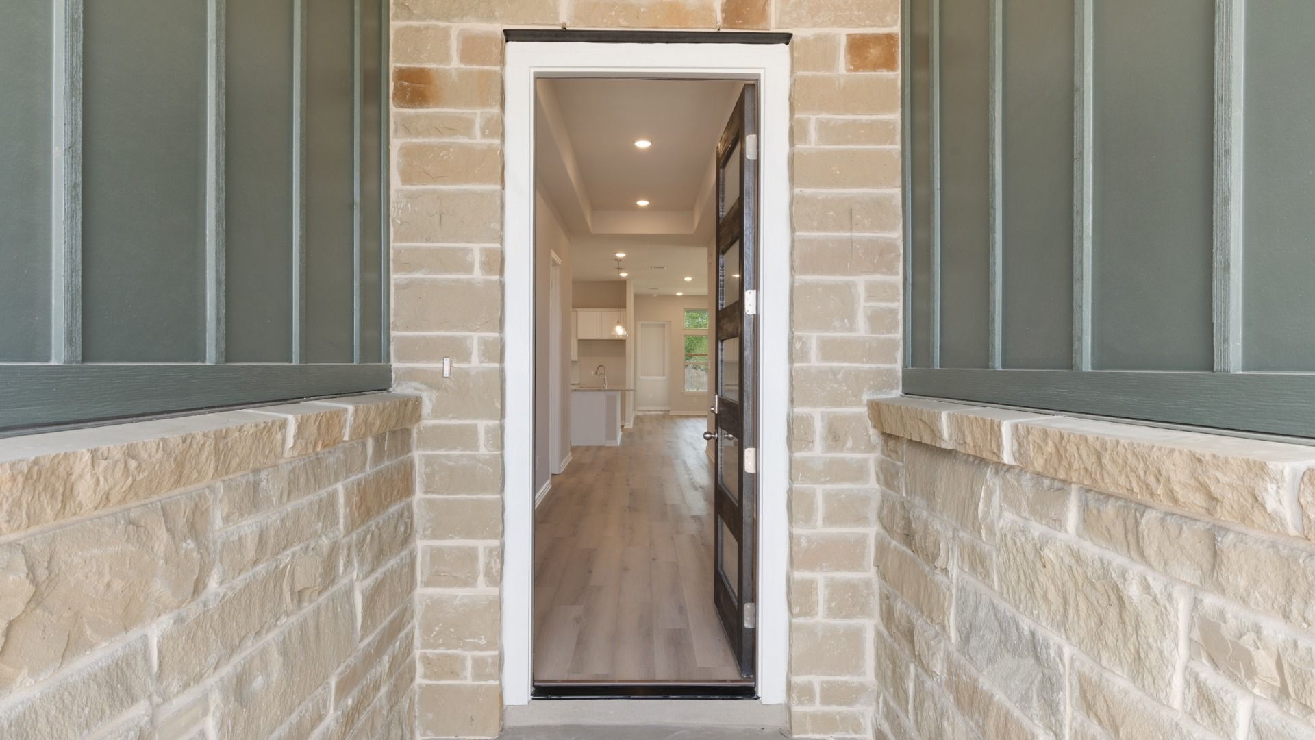 Beautiful exterior with rock-accented entry and inviting front porch.