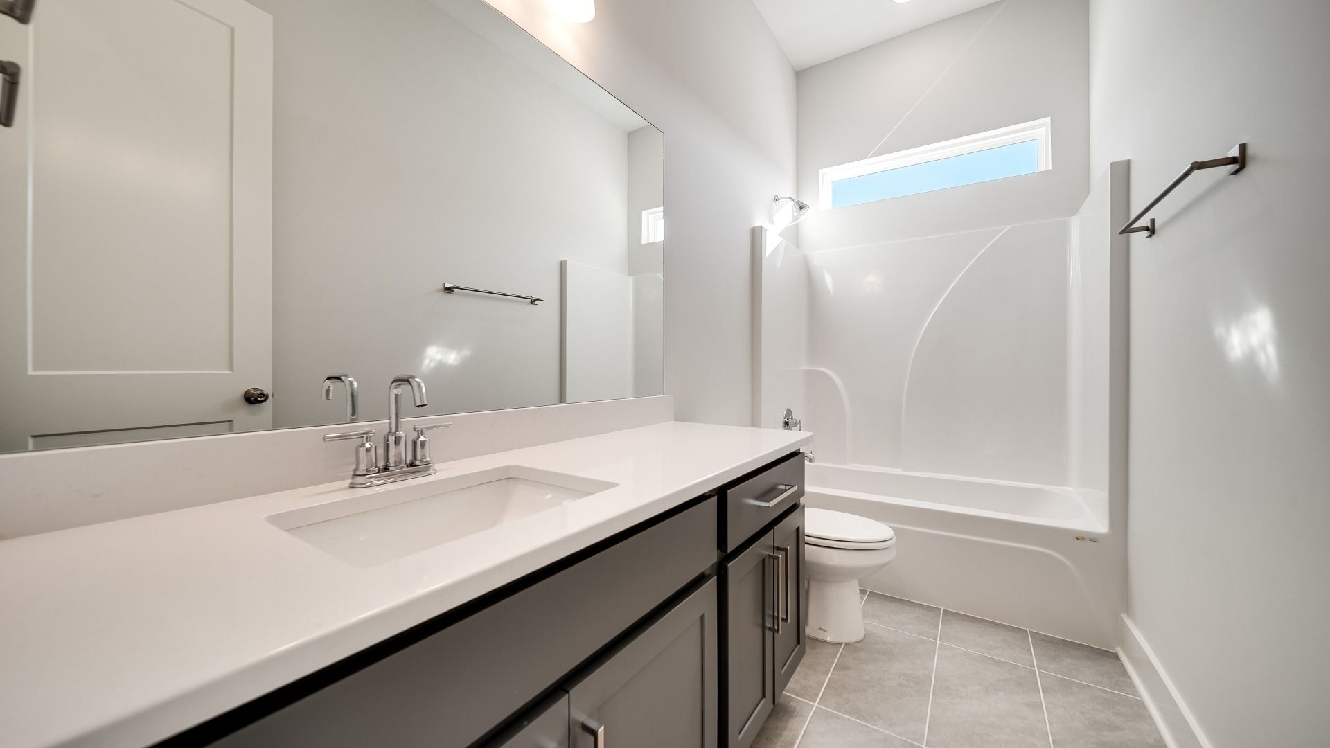 Vanity sink, toilet, and shower.