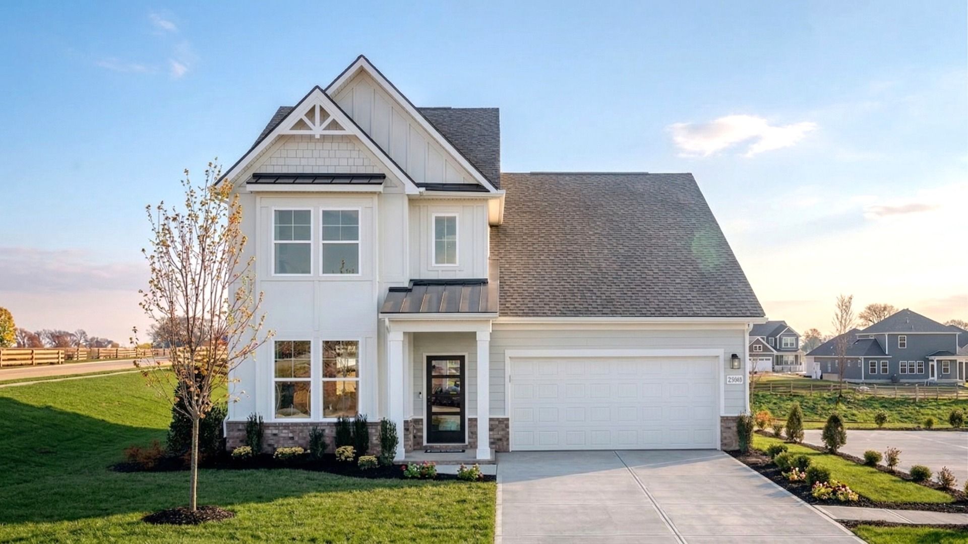 Exterior of home with white siding and brick accents