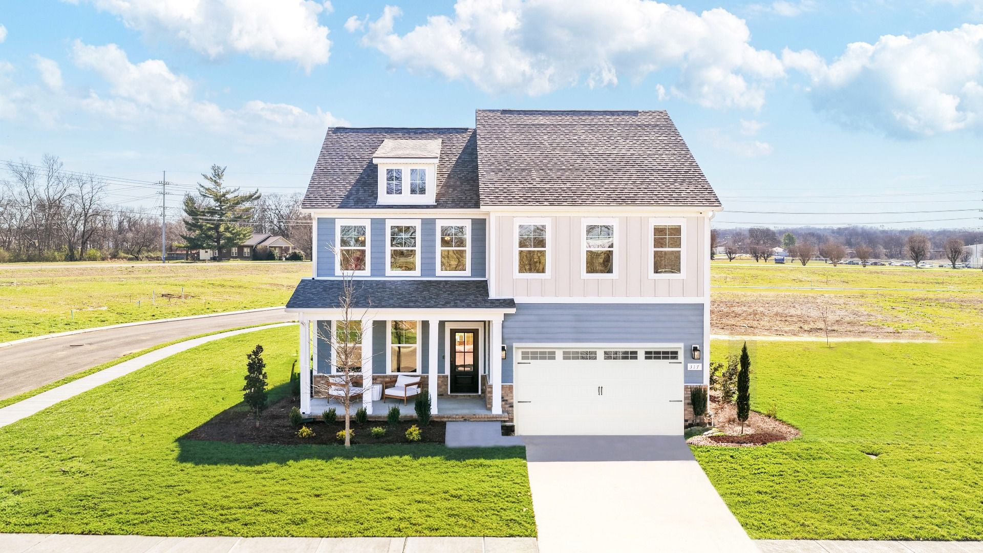 Home exterior with blue siding and white accents and covered front porch