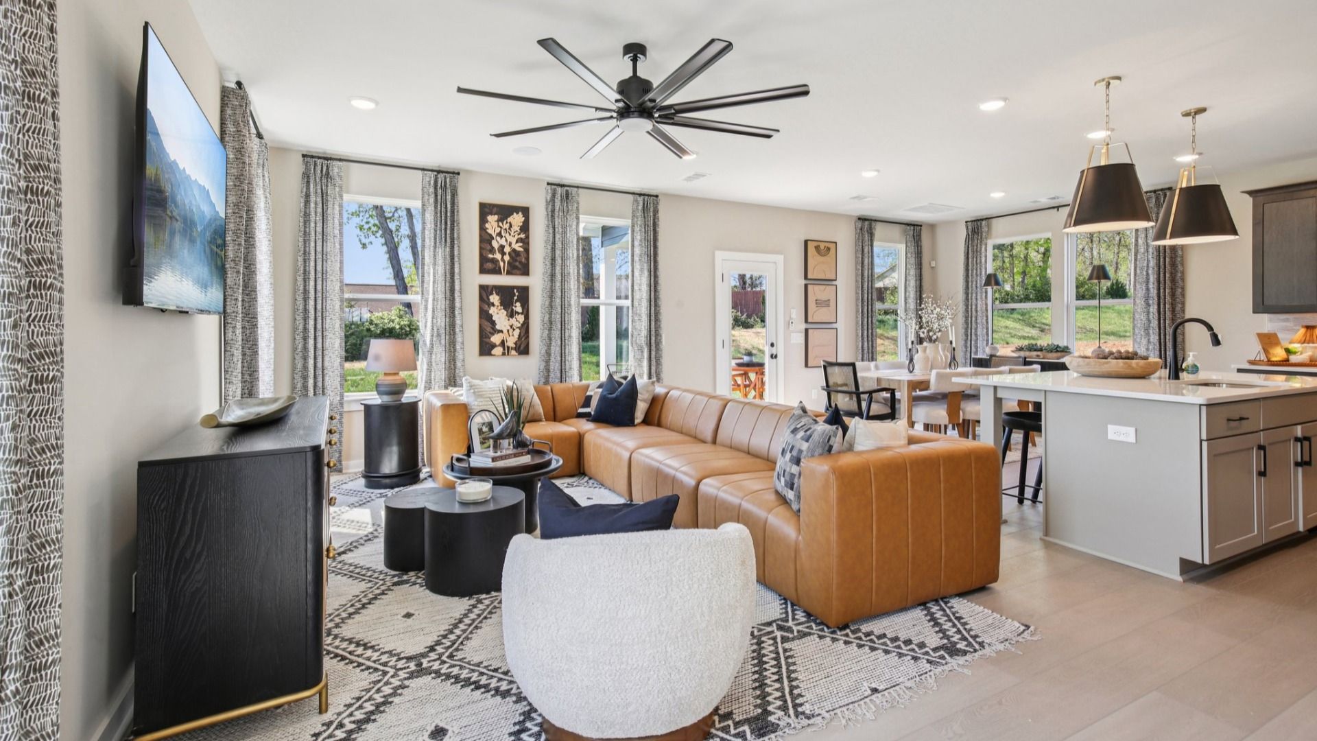First floor with cozy living room, kitchen island, and dining area