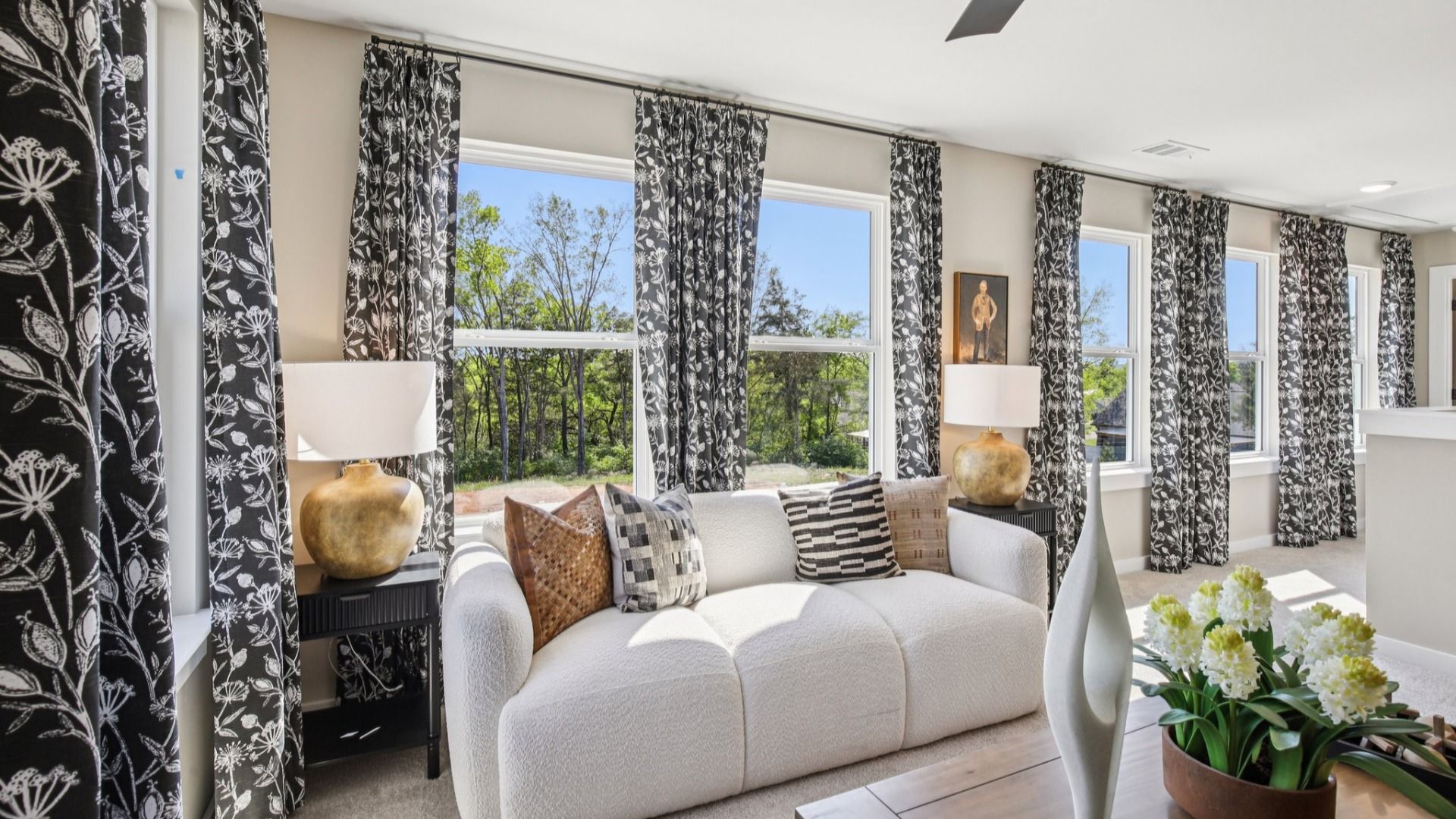 Loft area surrounded by large windows, allowing for tons of natural light in the home