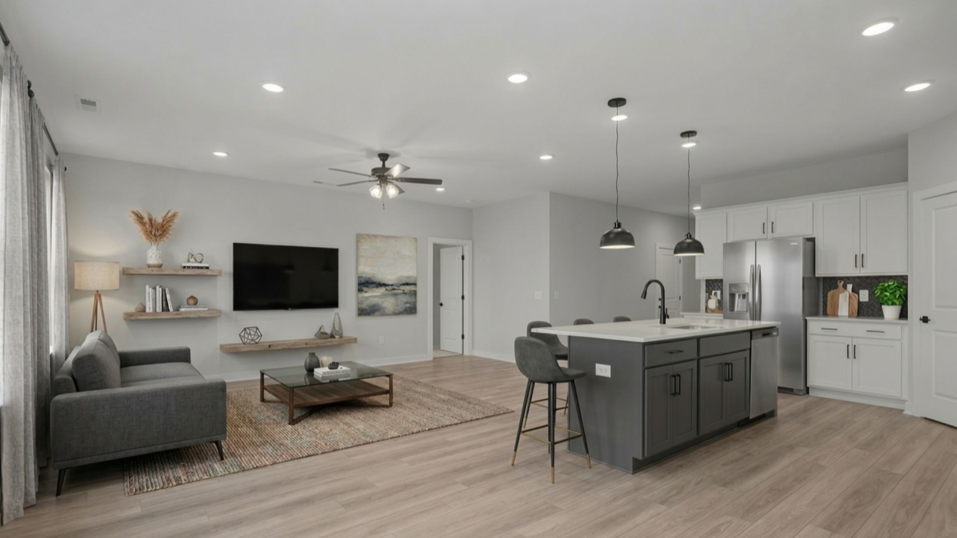 Virtually staged first floor with kitchen island, living room, and kitchen