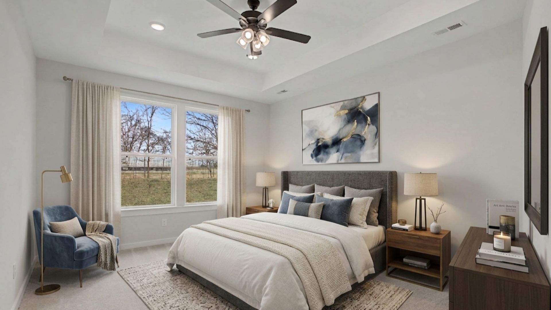 Virtually staged Primary bedroom with tray ceiling and fan in front of large windows.