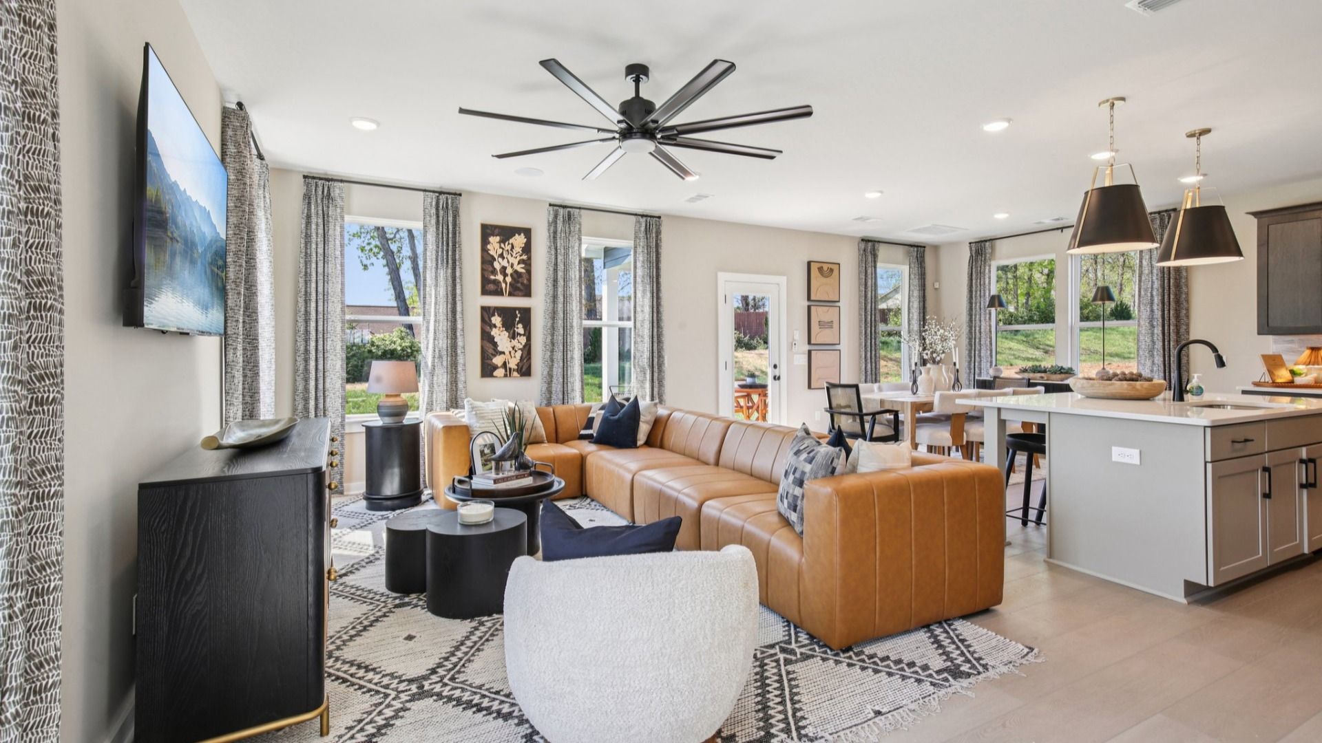 Open Concept first floor layout with cozy living room, kitchen island, and dining area near the back door