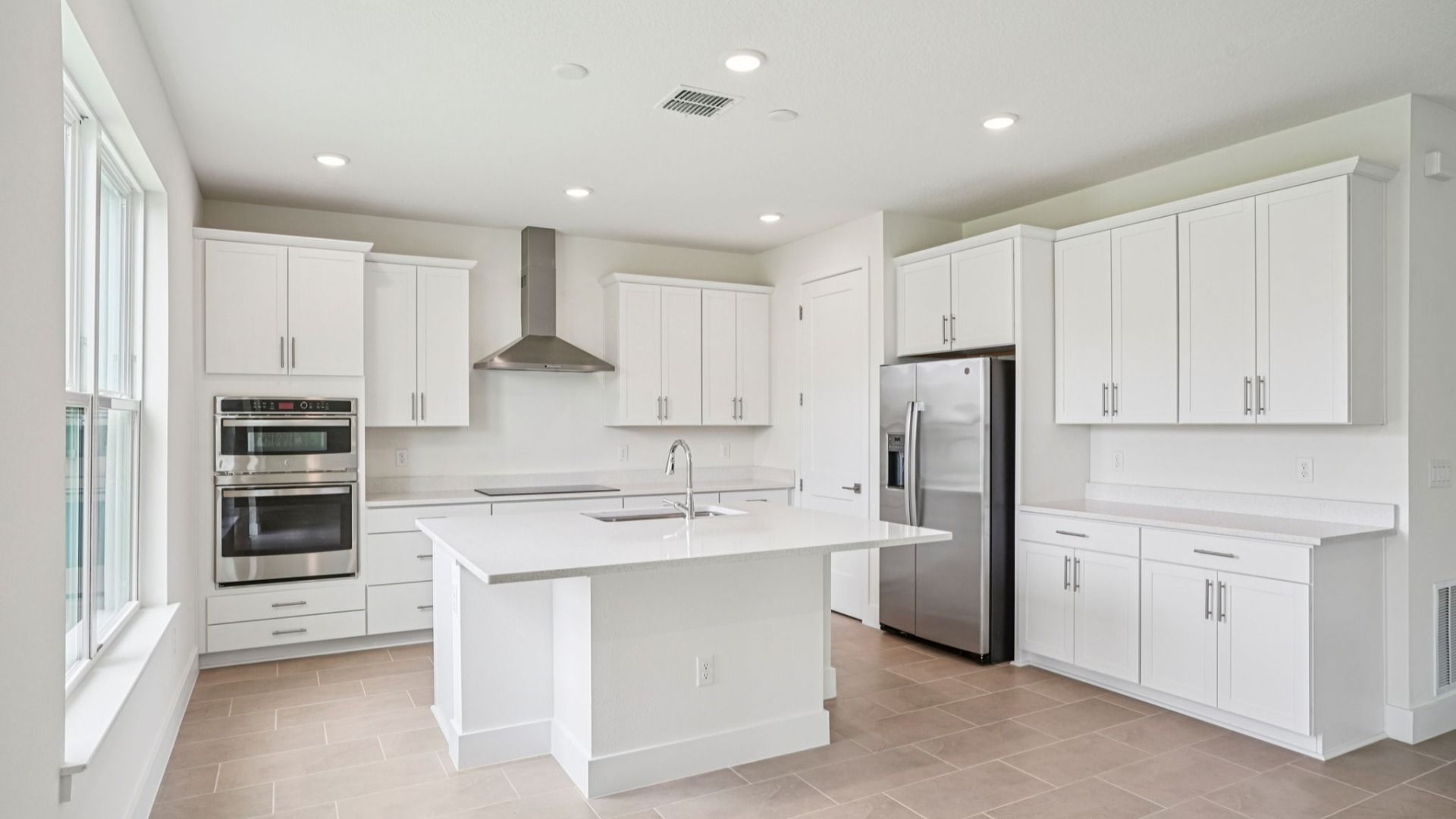 Plumeria Floor Plan featuring a bright kitchen with large island by DRB Homes in Trailside located in Mount Dora, FL