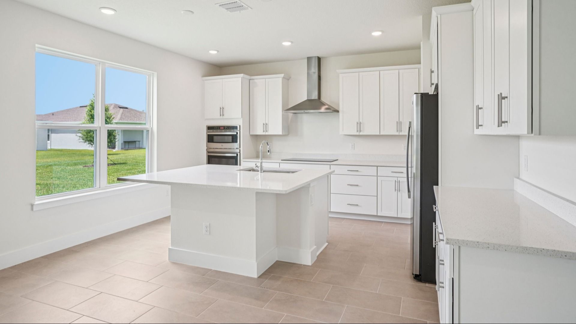 Plumeria Floor Plan featuring a bright kitchen with large island by DRB Homes in Trailside located in Mount Dora, FL