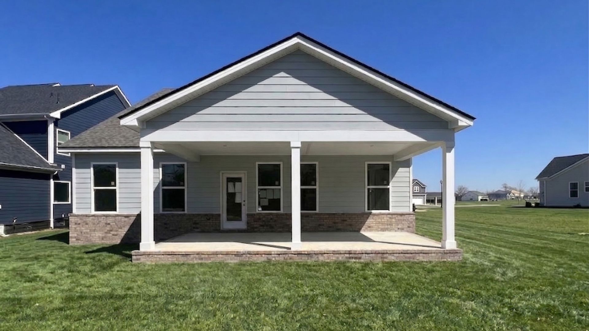Rear exterior of home showing covered back patio and backyard area