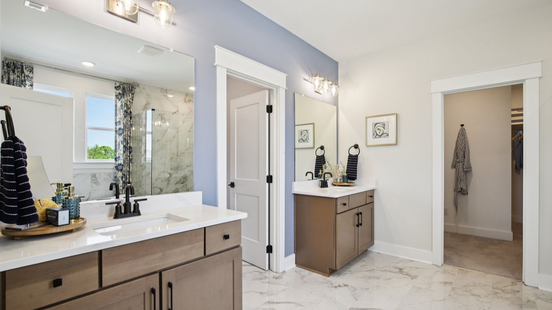Split dual vanities on either side of water closet, and nearby walk-in closet