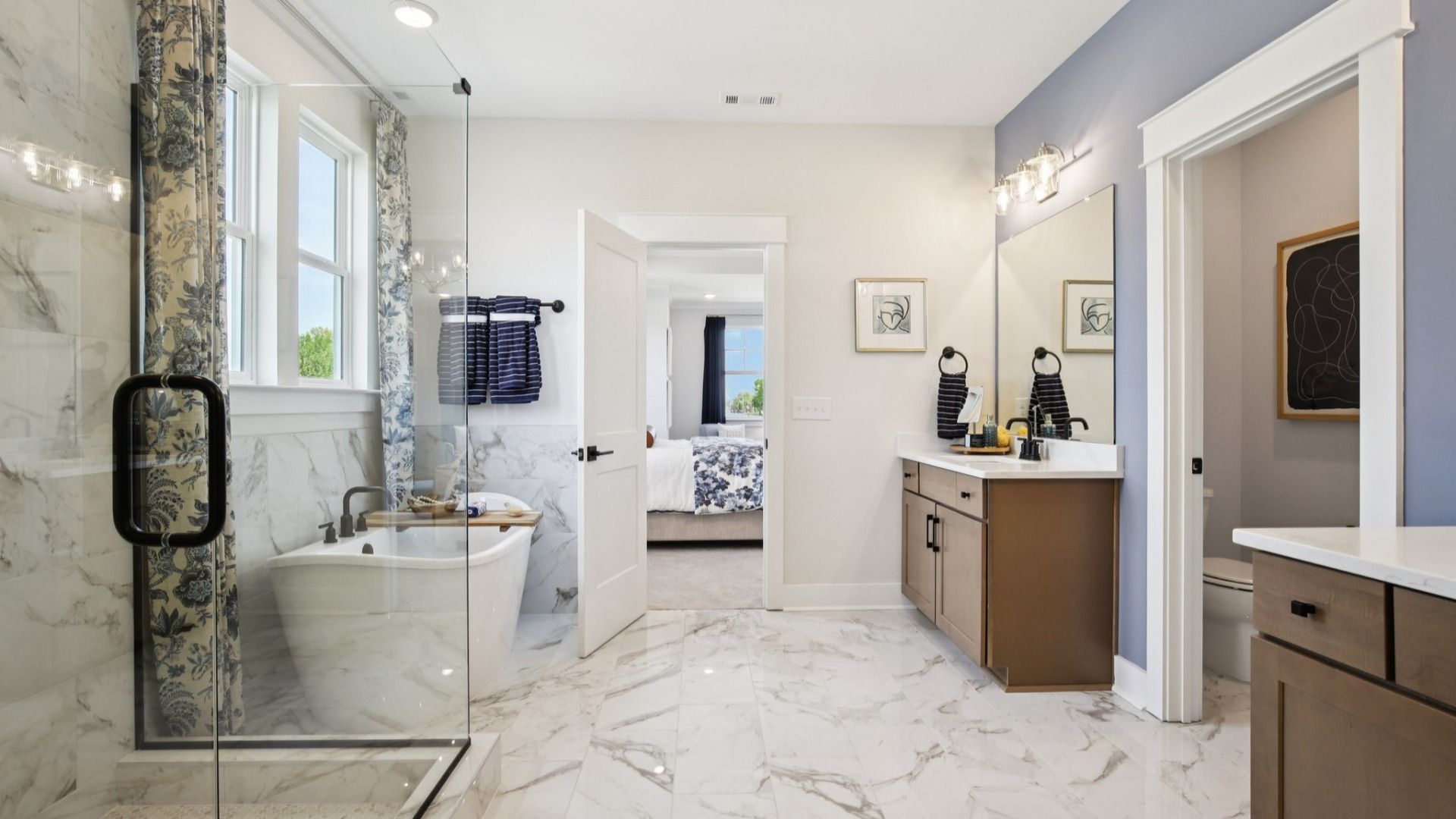 Tiled floor, free-standing tub surround, and shower with glass surround