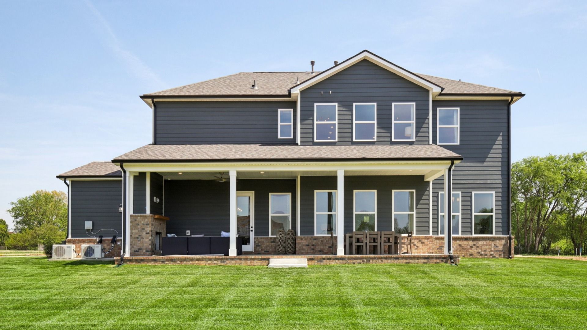 Backyard and large covered patio with fireplace and patio furniture