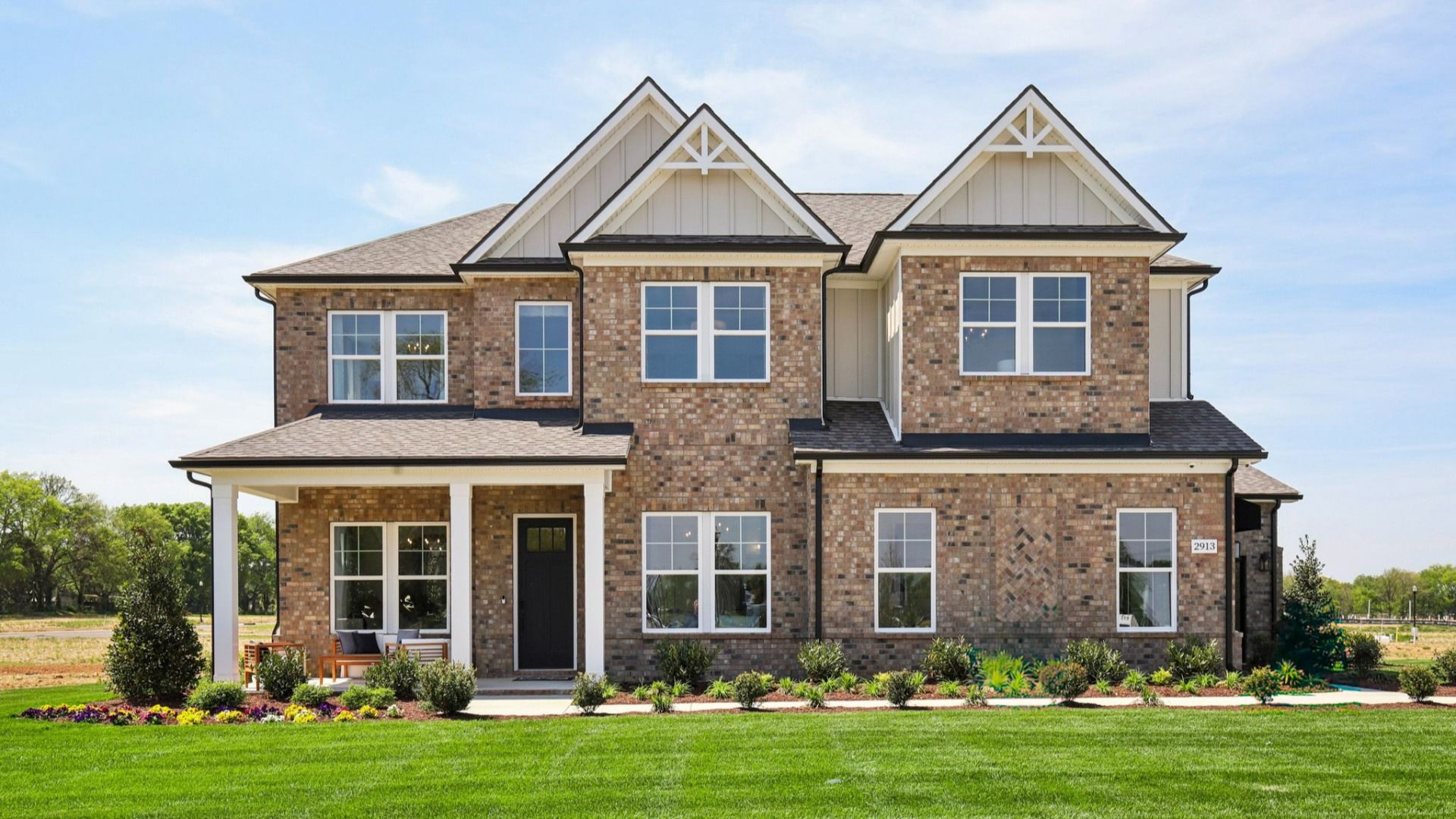 Full brick front exterior with siding accents and a side-entry 3-car garage