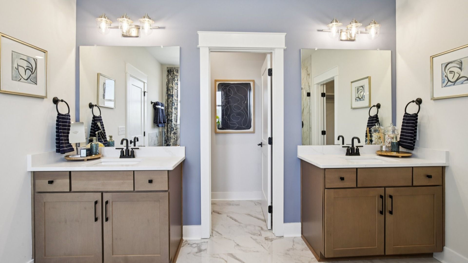 Split double vanity on either side of the water closet, with nearby walk-in closet