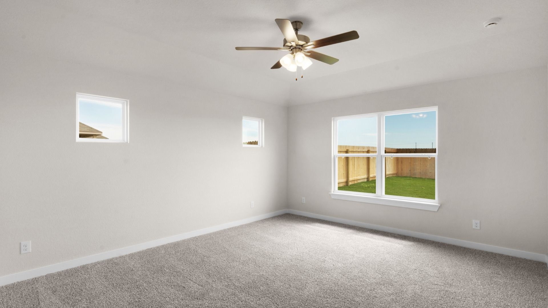 Owner's Suite with plenty of Natural Light and a Ceiling Fan, Overlooking the Backyard