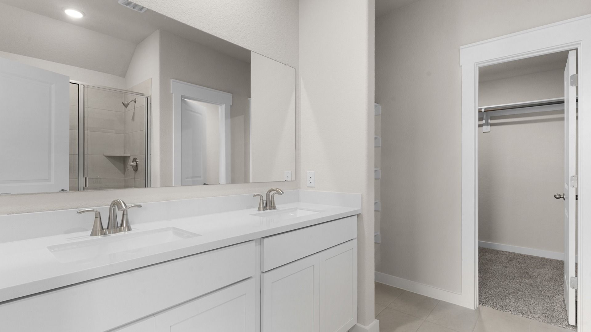 Owner's Bath with Dual Vanity, Cabinets for storage, and Spacious Closet