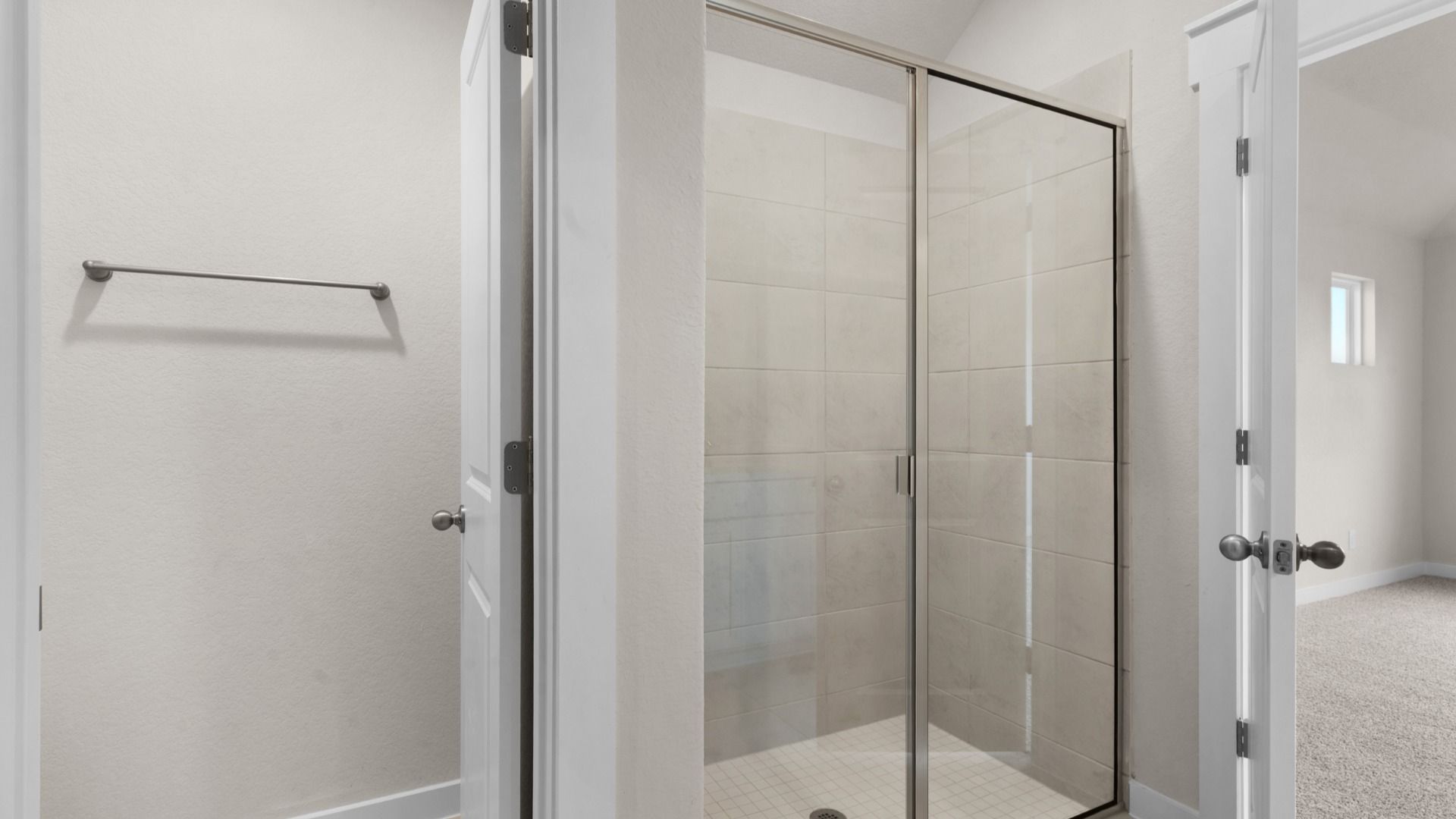 Owner's Bath with Private Water Closet, Towel Rod, and Tile Surround Framed Glass Shower