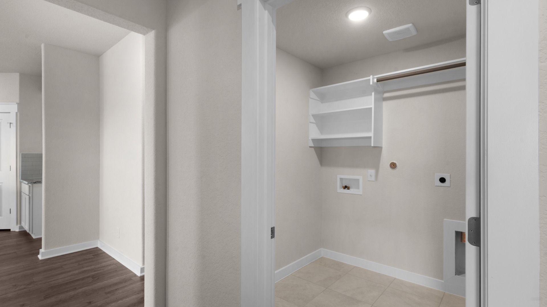 Laundry with Built-In Shelving and Rod
