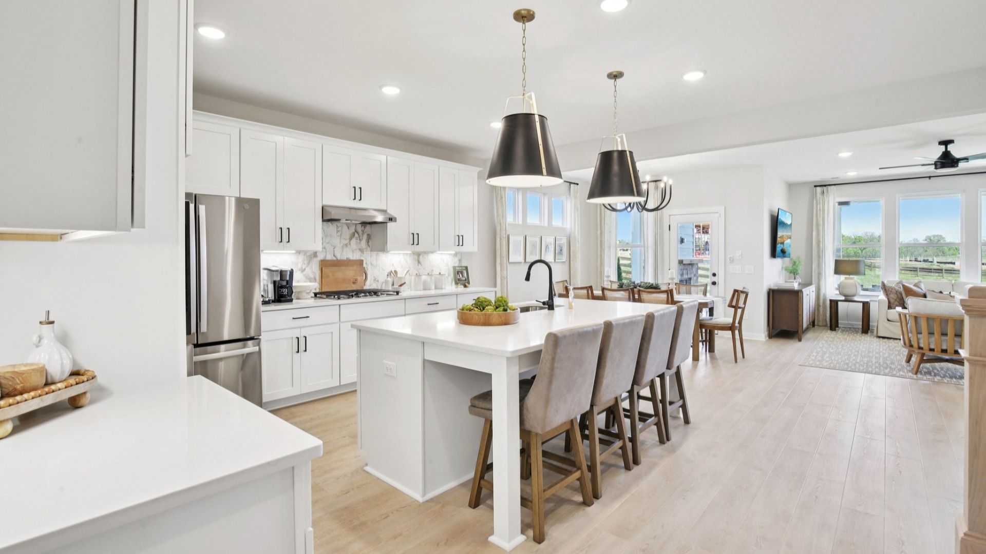 Large Kitchen with extended kitchen island, nearby dining area and gathering room