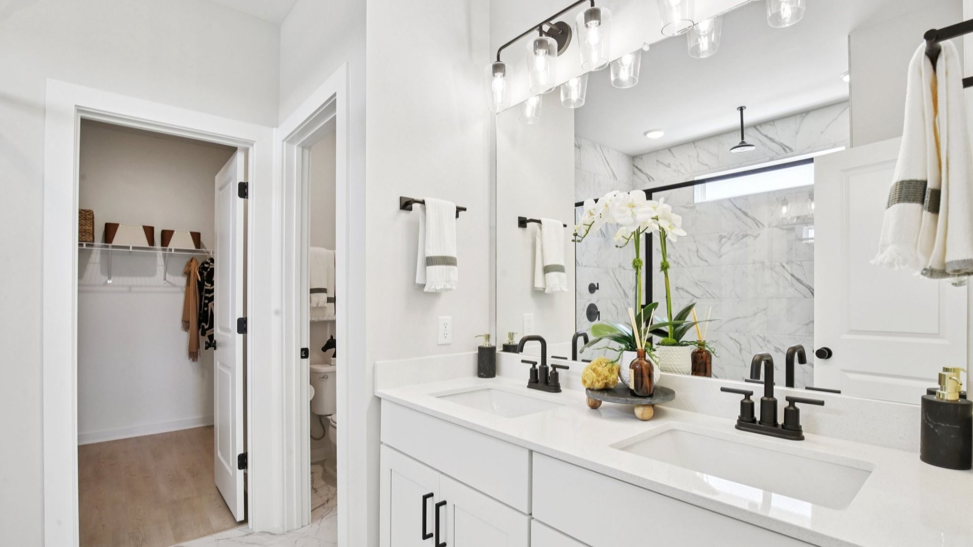 Private en-suite bathroom with quartz countertops, water closet, and dual vanity