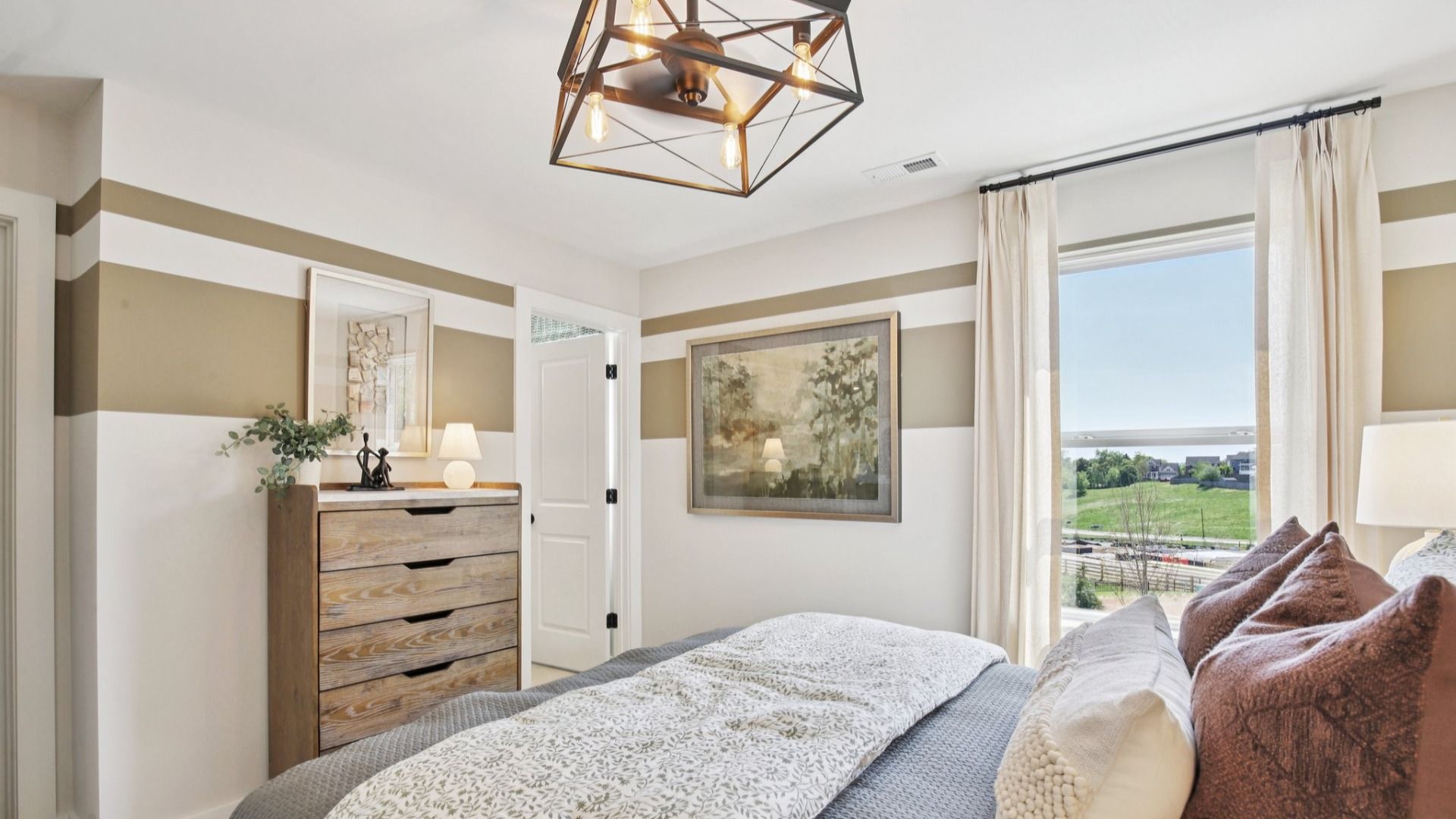 Bedroom with large window and en-suite bathroom