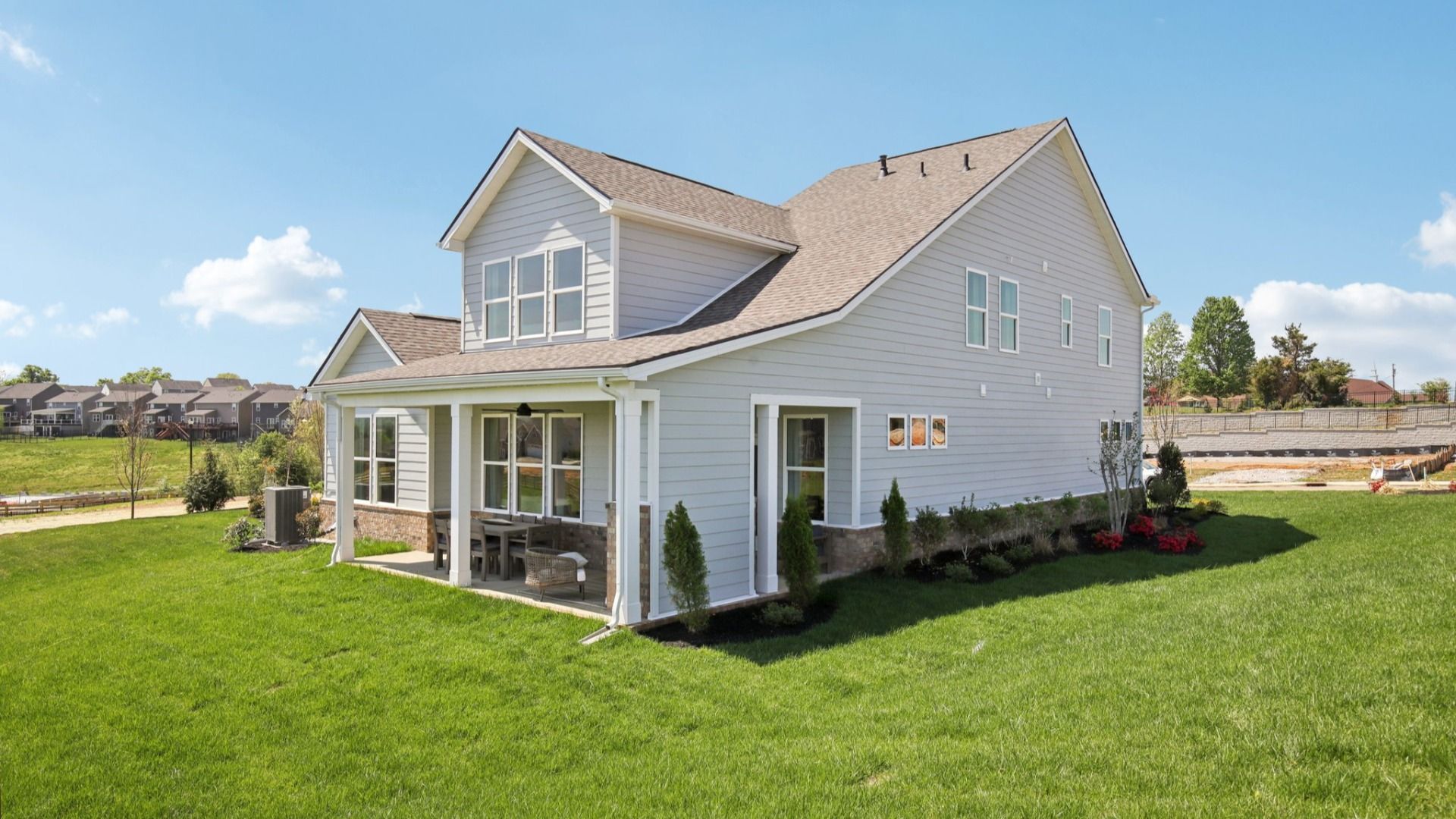 Back and side yard of home showing the covered rear patio