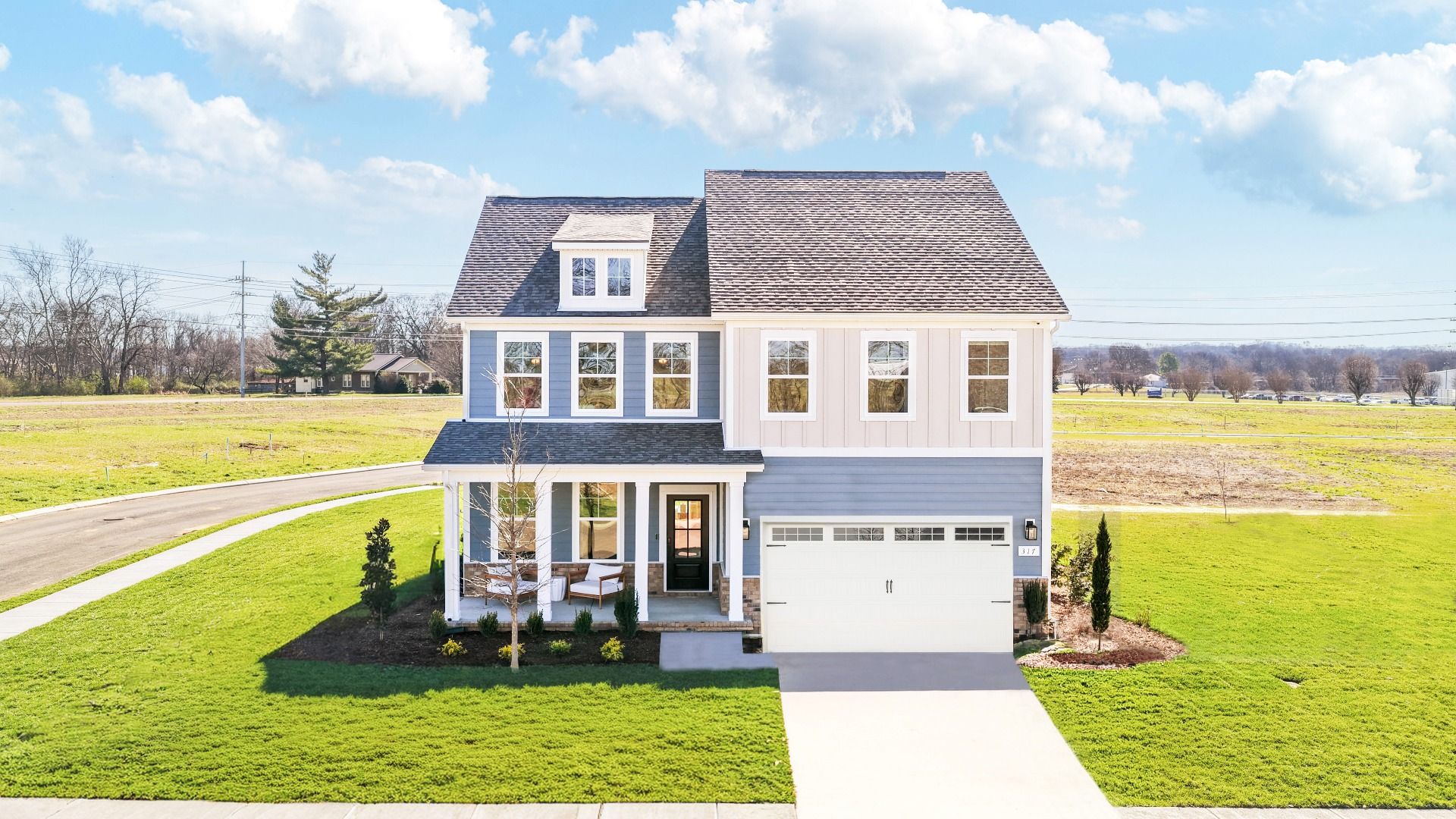 Exterior of home with blue and white siding and covered porch