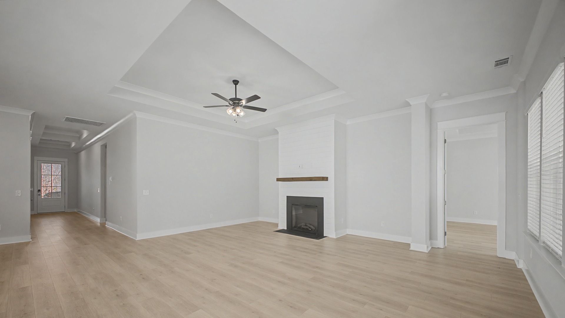 Gathering Room Area with tray ceiling and fireplace