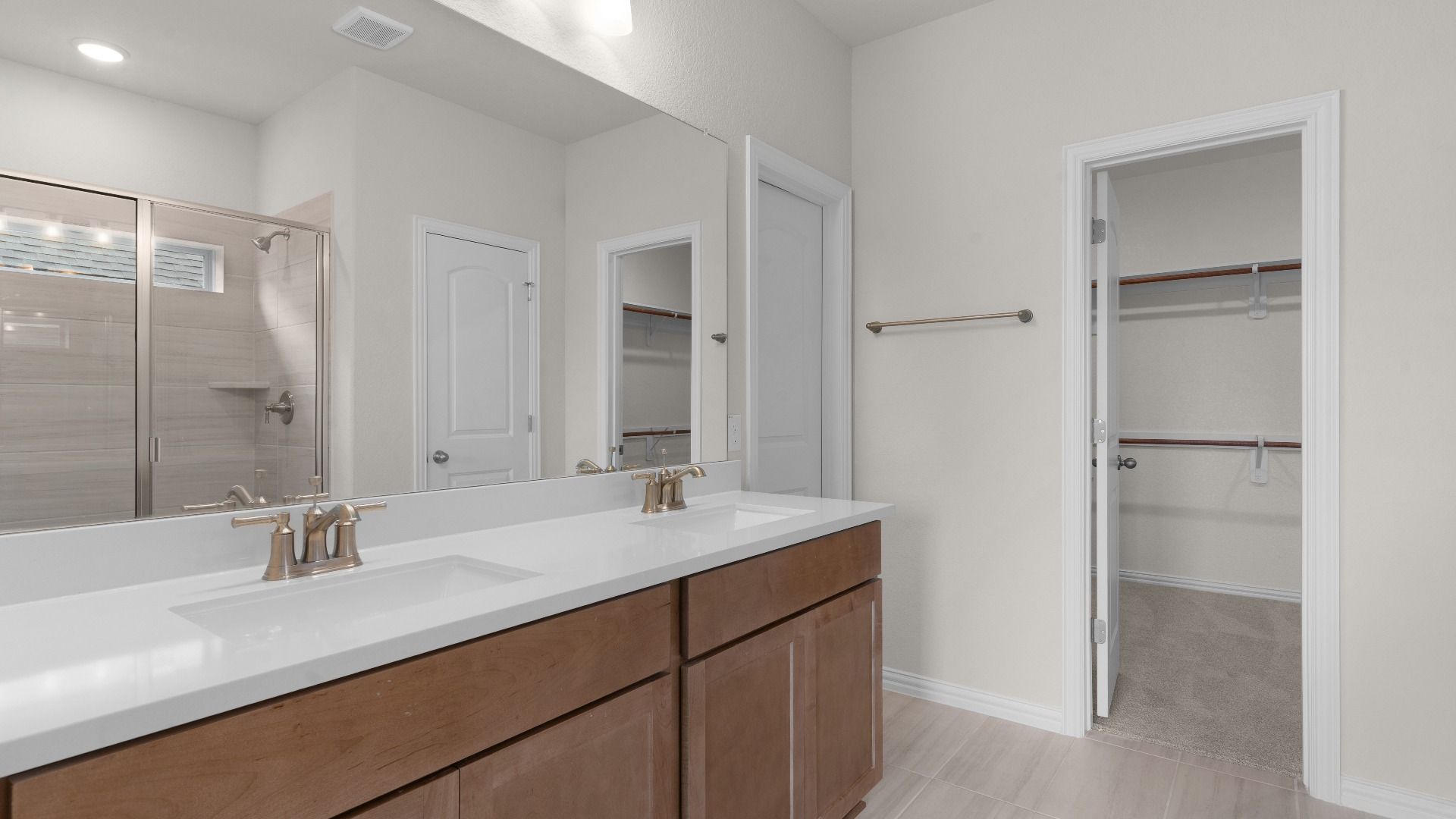Owner's Bathroom with Dual Vanity, Ceramic Tiled Shower, Closet, Window