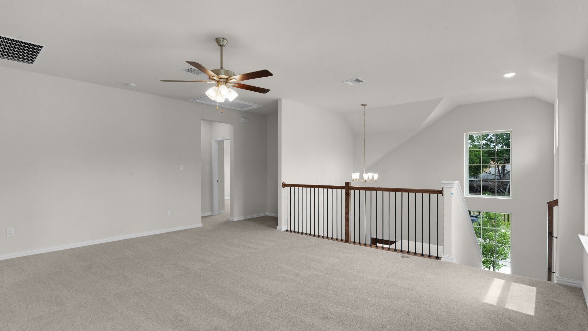 Loft Area with Ceiling Fan on Second Level