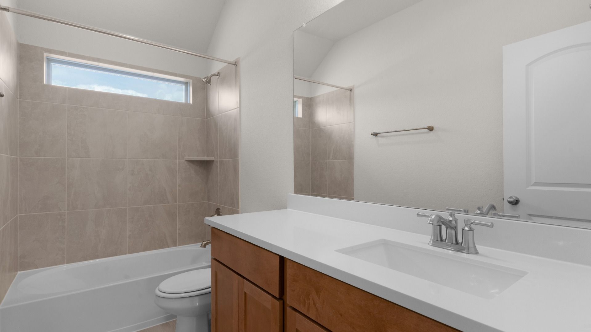Secondary Bathroom with Vanity, Ceramic Tile Shower/Bath Combo, Window