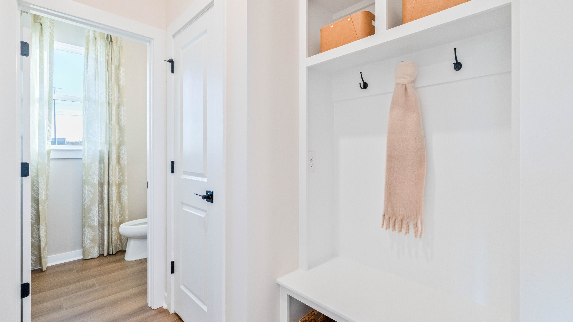 Added convenience of extra storage and built-in drop-zone near garage entry door.