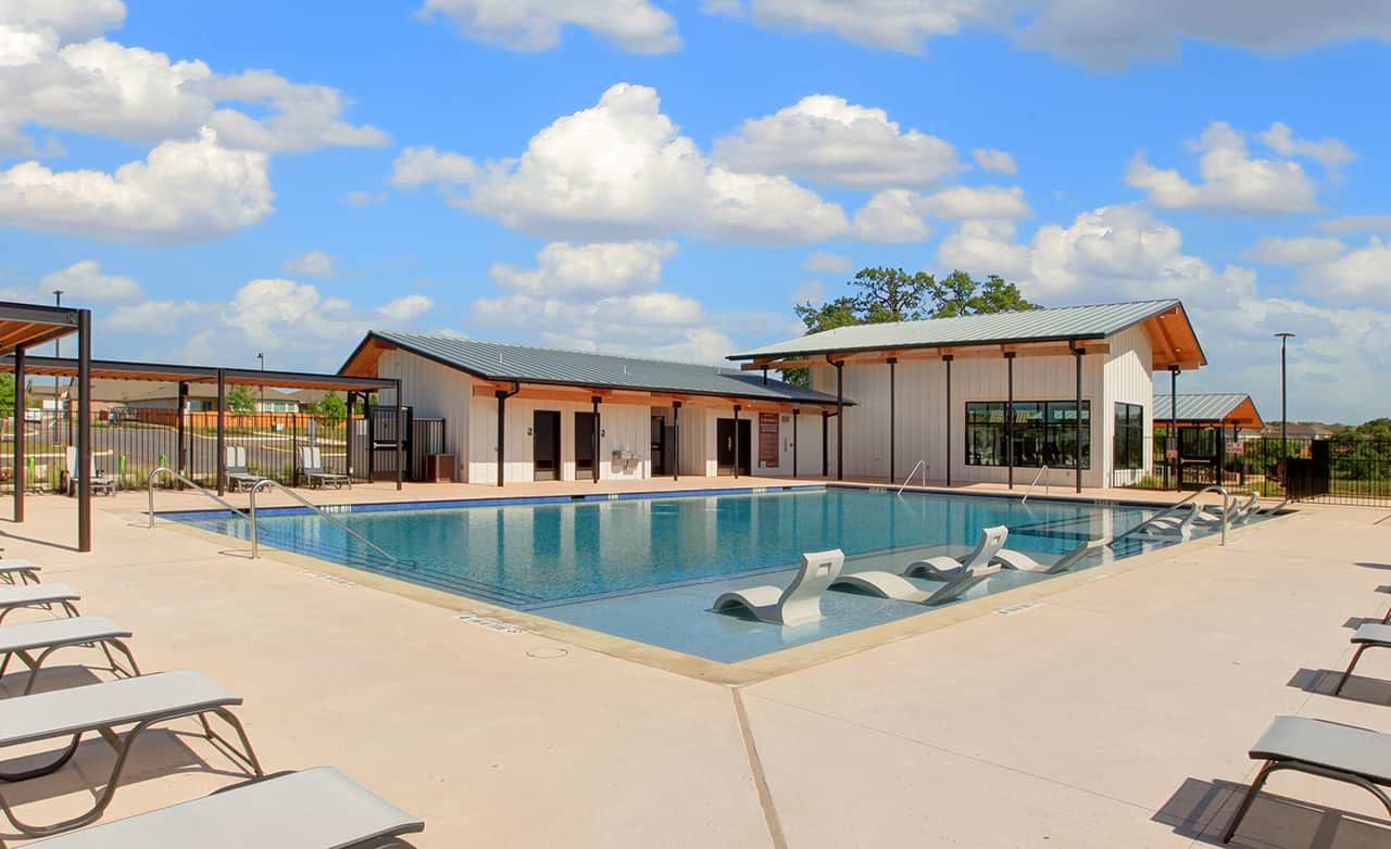 Luxuriate in the sleek pool and barn-style clubhouse at Meyer Ranch, Texas, epitomizing modern community elegance.