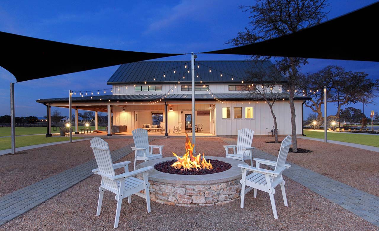 Experience refined living with a modern barn design, elegant fire pit, and ambient string lighting in Meyer Ranch.