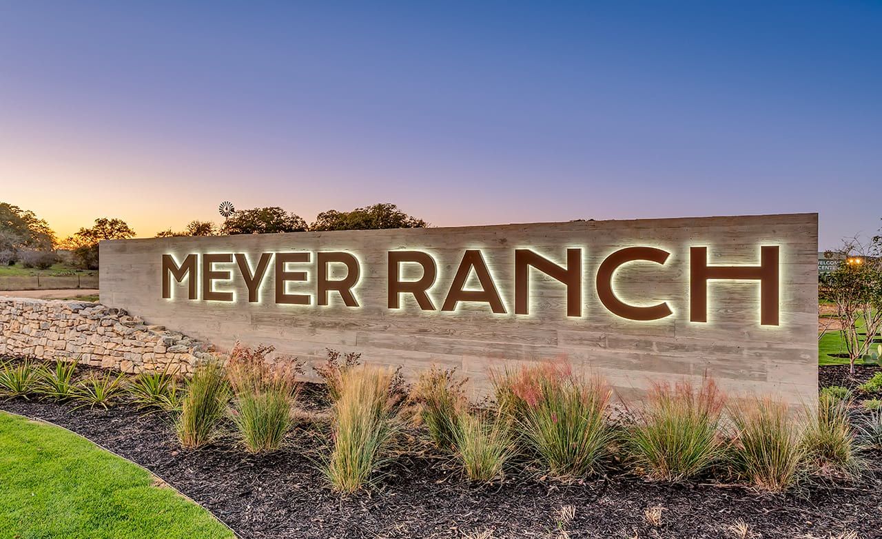Experience modern elegance with the illuminated Meyer Ranch entrance, nestled in scenic Texas hill country.