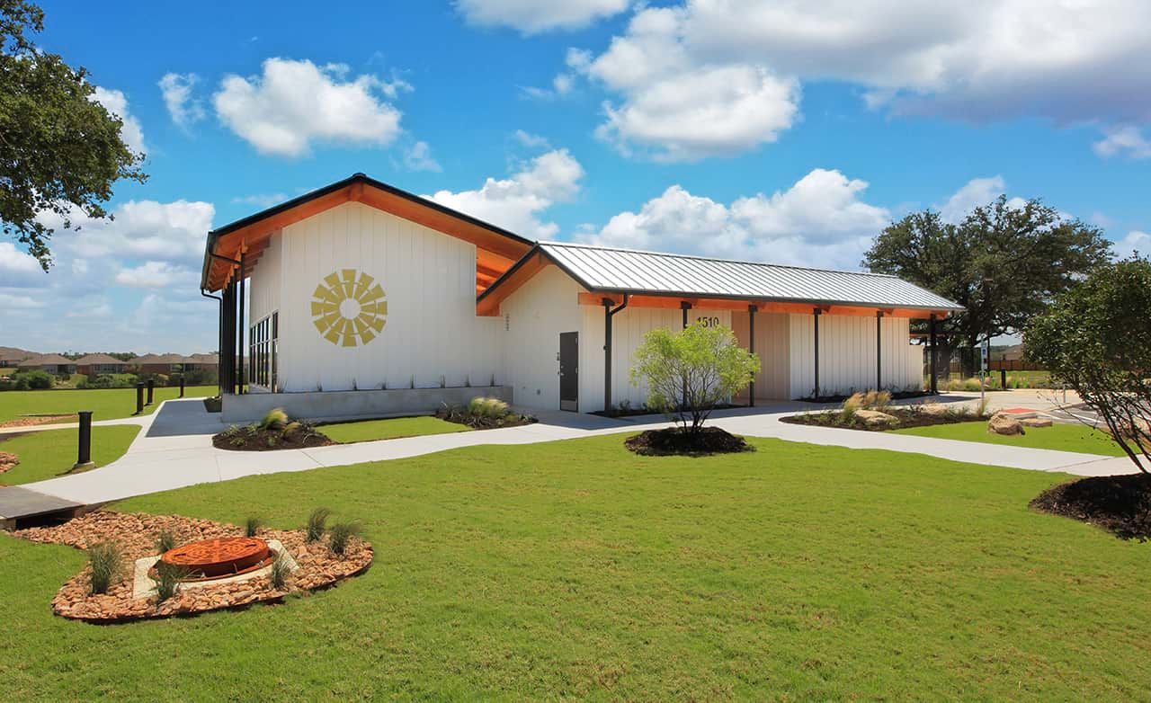 Sleek metal roofing and expansive green landscapes define this Meyer Ranch architectural gem.