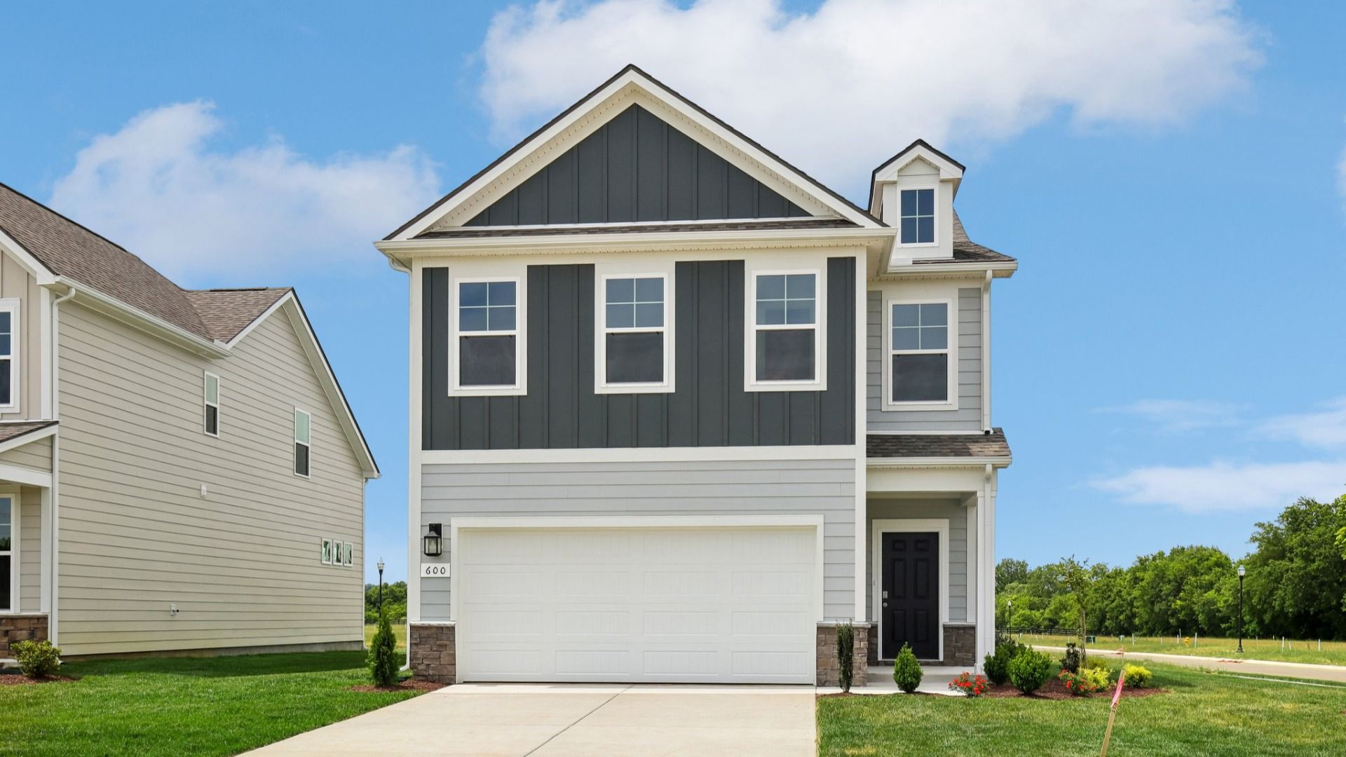 Home exterior with two tone blue siding and 2-car garage