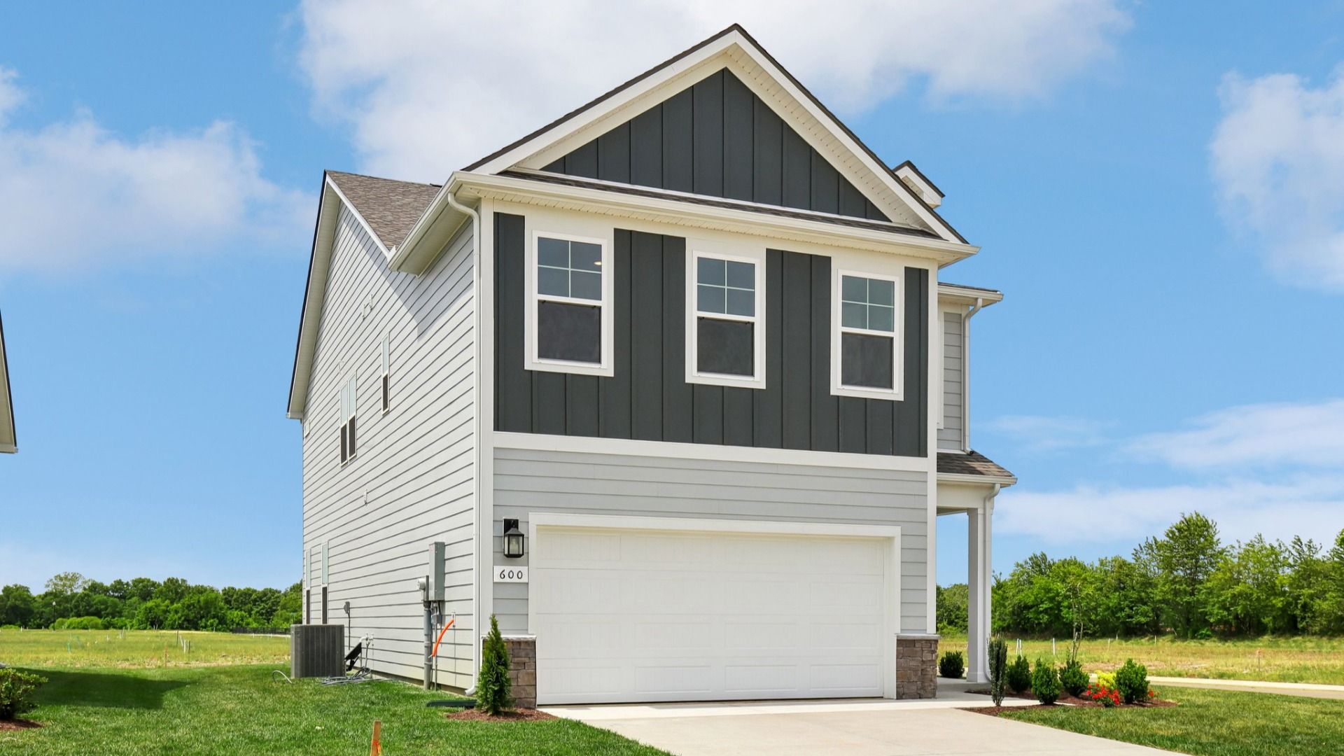 Home exterior with two tone blue siding and 2-car garage