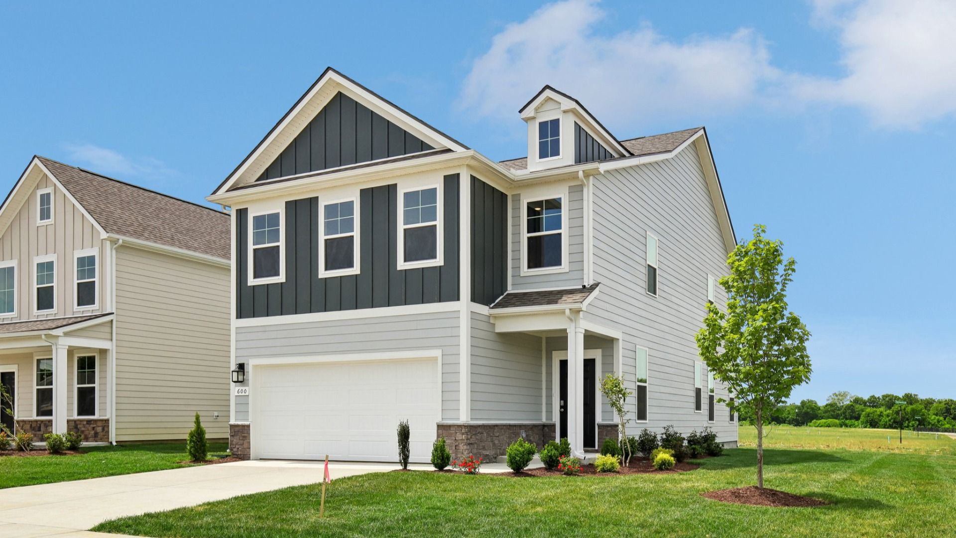 Home exterior with two tone blue siding and 2-car garage