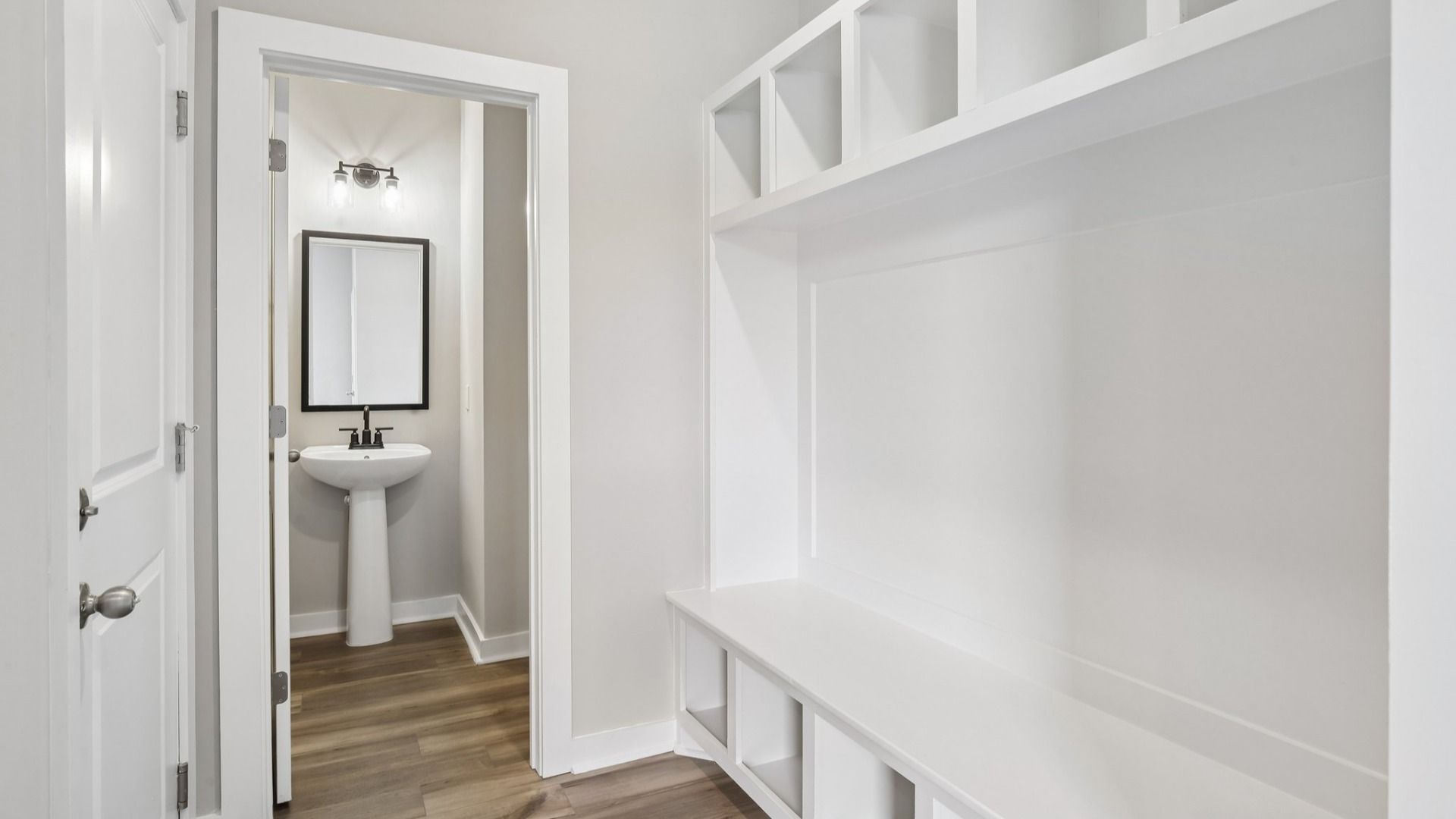 Powder room and built-in drop zone near front entry