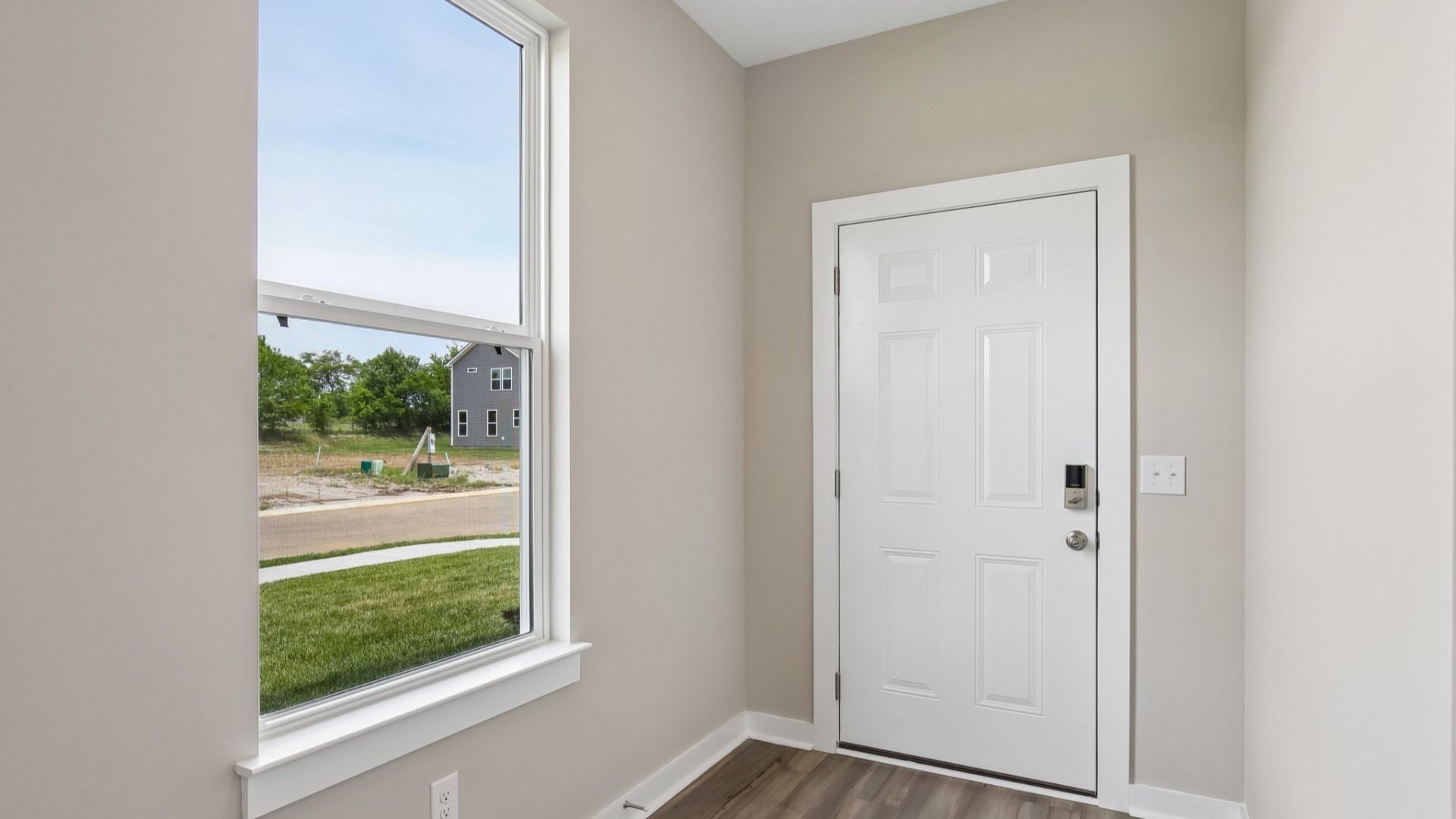 Front door to home with nearby window