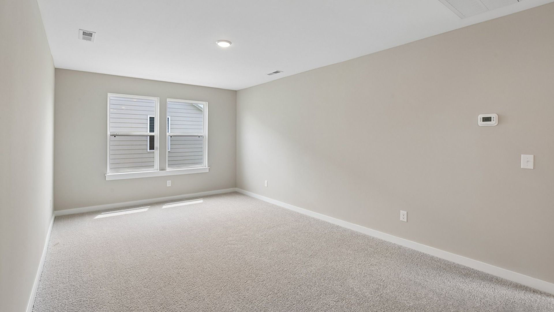 Second Floor Loft area with windows and carpet