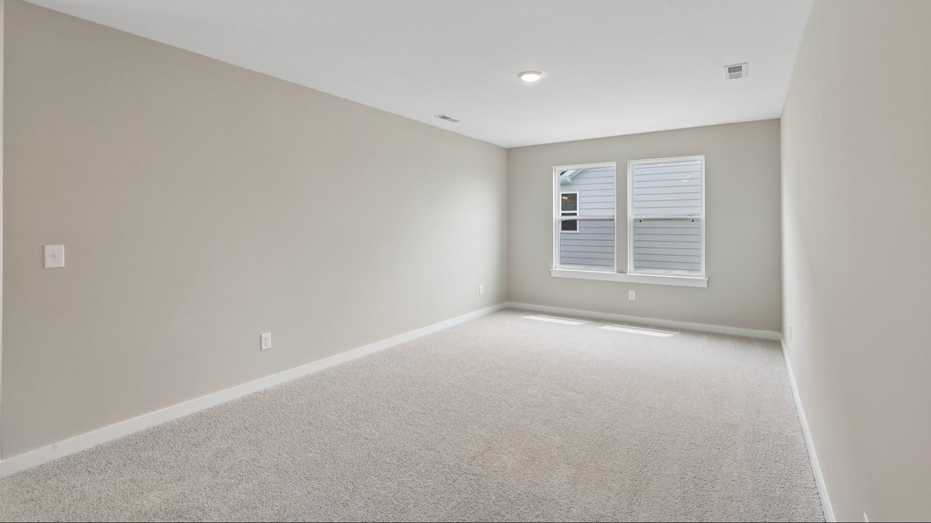 Second Floor Loft area with windows and carpet