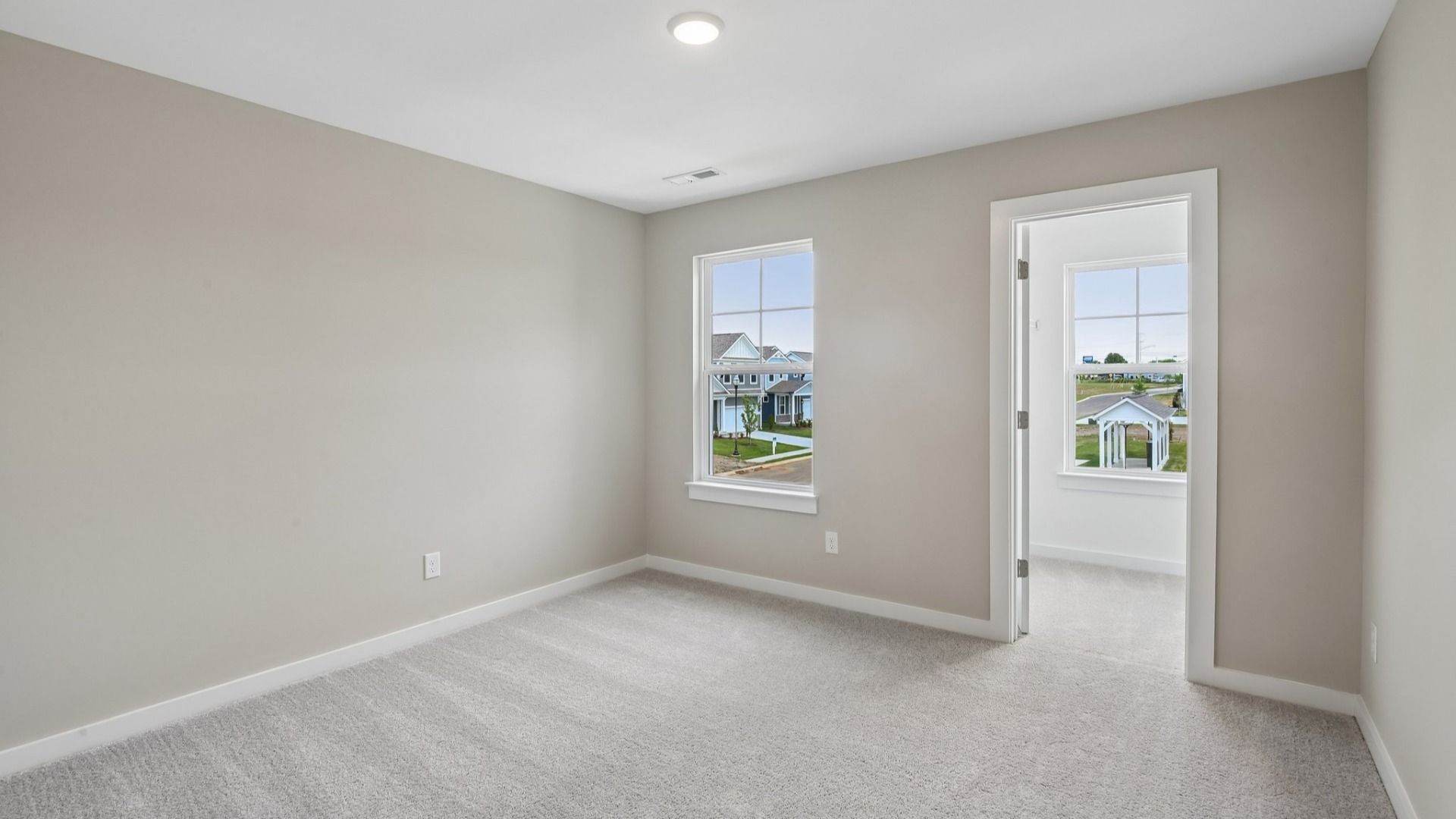 Bedroom with walk-in closet and window