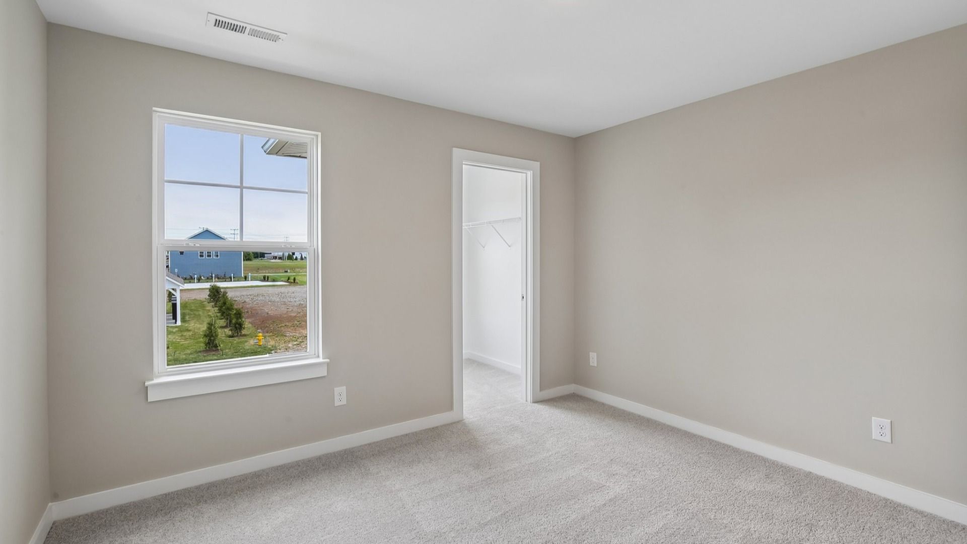 Bedroom with walk-in closet and window