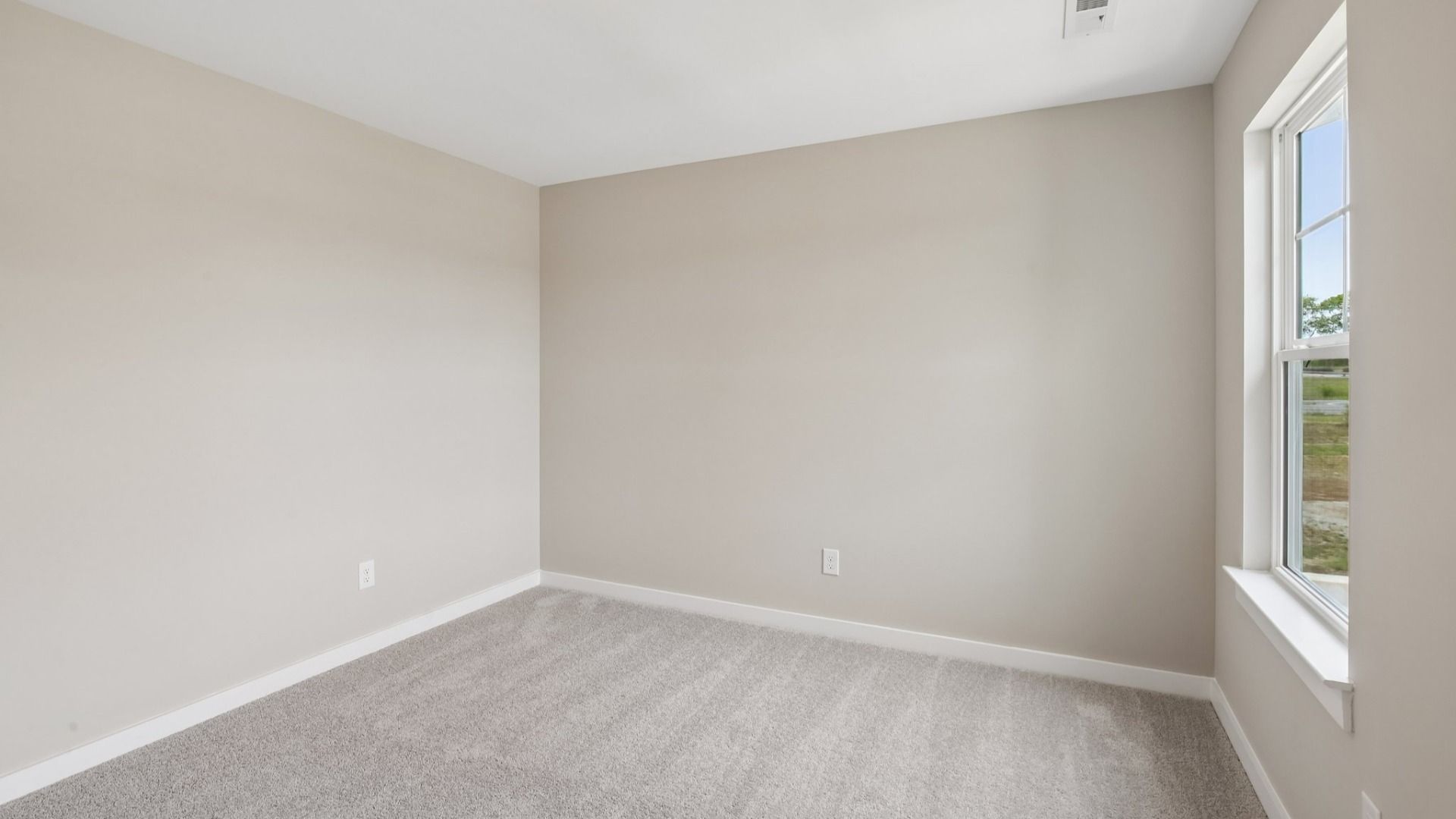 Bedroom with carpet and window