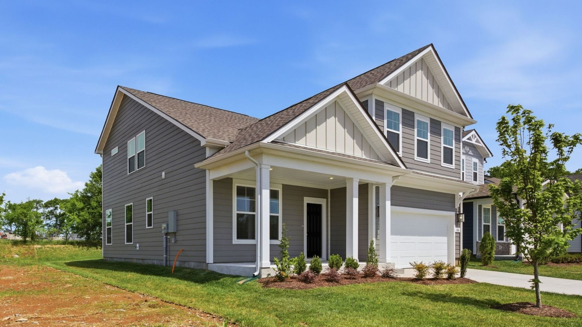 Home exterior with two-car garage and black door