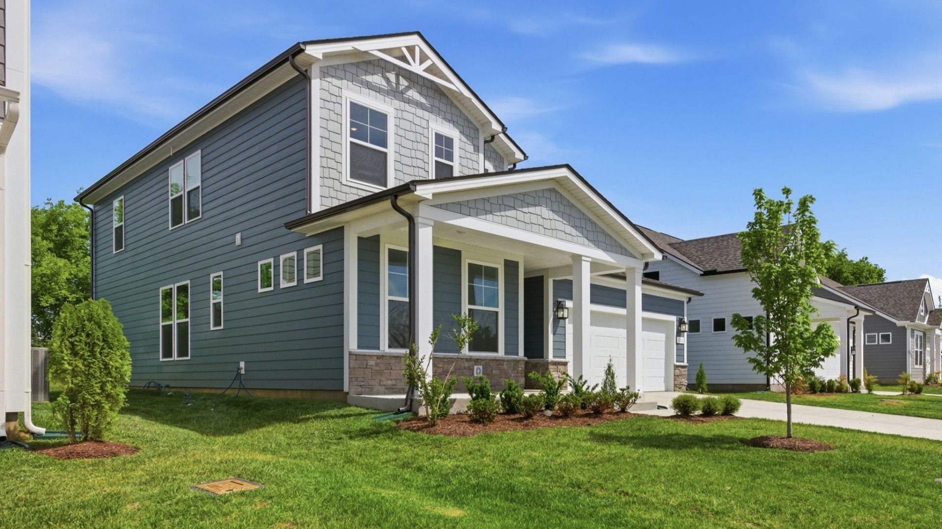 Home exterior with blue siding and two car garage